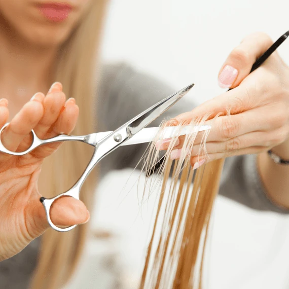 Image of stylist doing a hair cut & style at Lusso Hair Studio & Spa located in Winston-Salem, NC